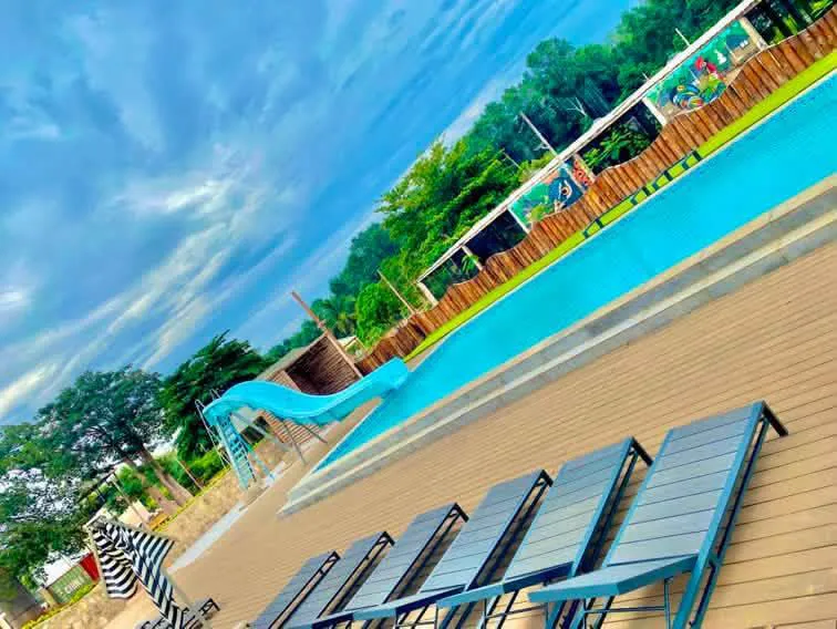 Swimming pool with water slide and mural fence